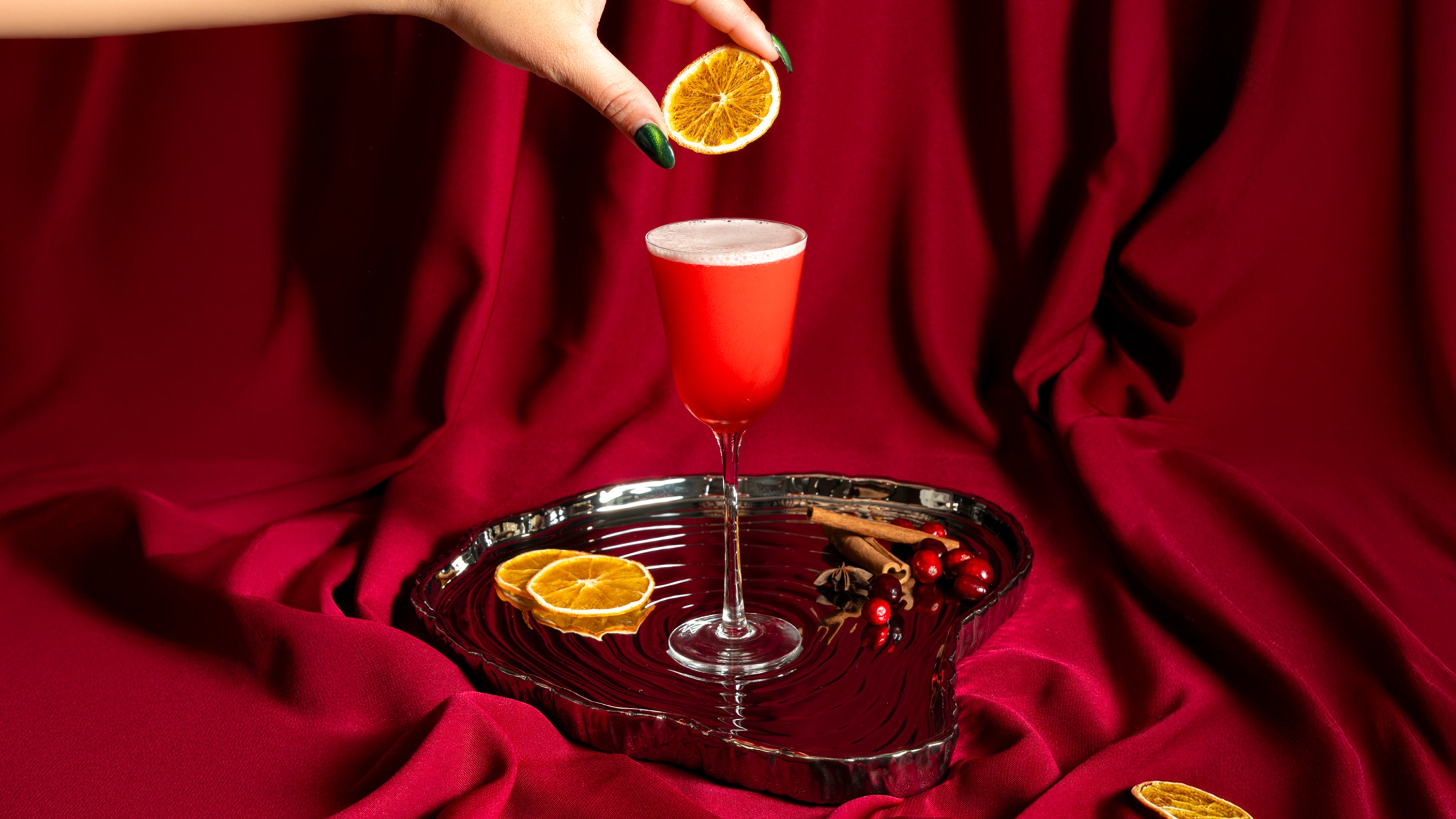 Dropping Orange into Cocktail Glass