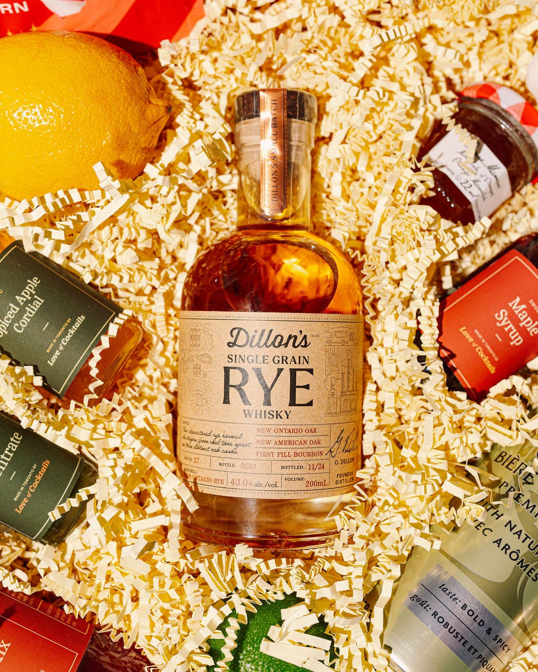 Assorted miniature bottles of alcohol in a decorative box with shredded paper