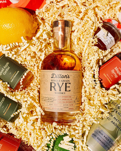 Assorted miniature bottles of alcohol in a decorative box with shredded paper